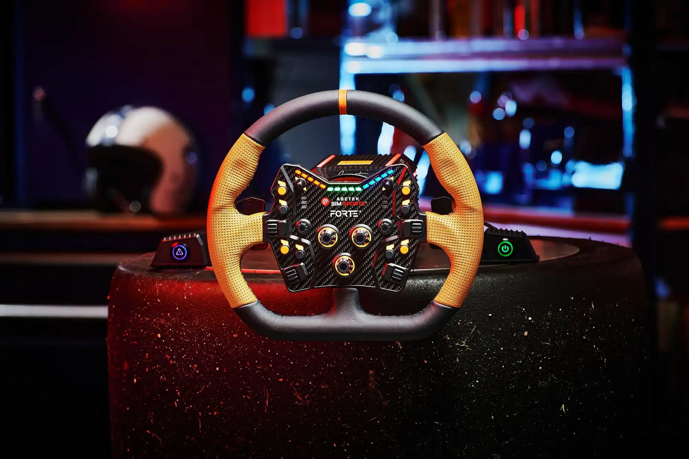 A high-tech racing simulation steering wheel with numerous buttons and controls, featuring a carbon fiber look and yellow textured grips.